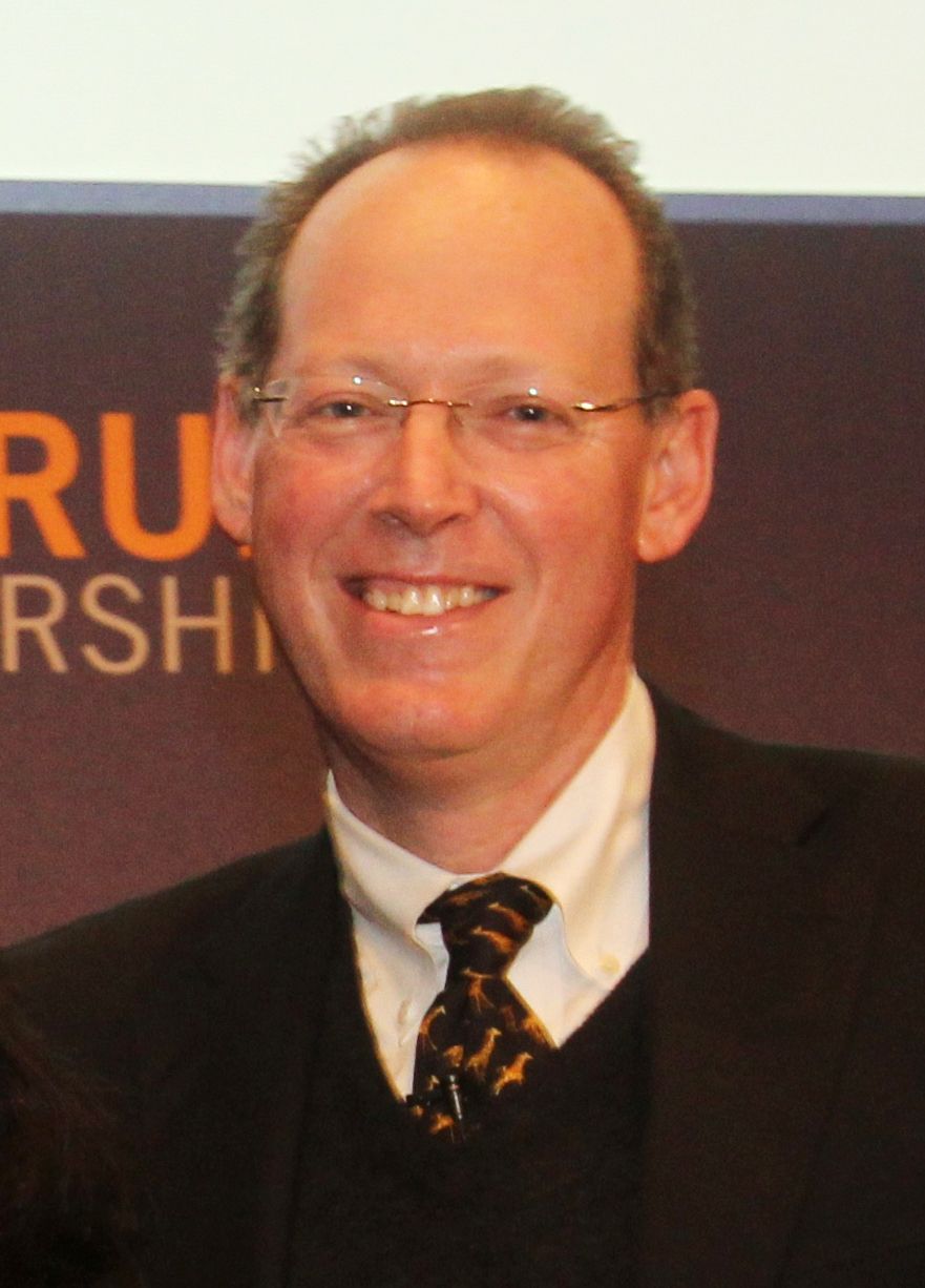 Paul Farmer smiling, in a jacket and tie, in 2011.